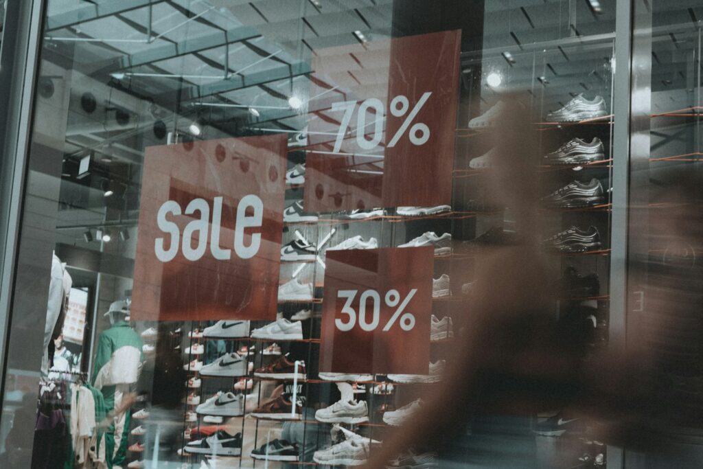 A storefront announces a sale of 70% and 30% off.