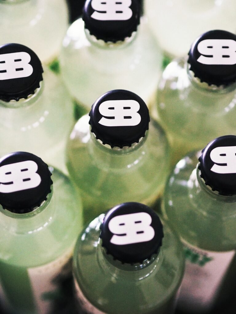 A close up of a bunch of green soda bottles