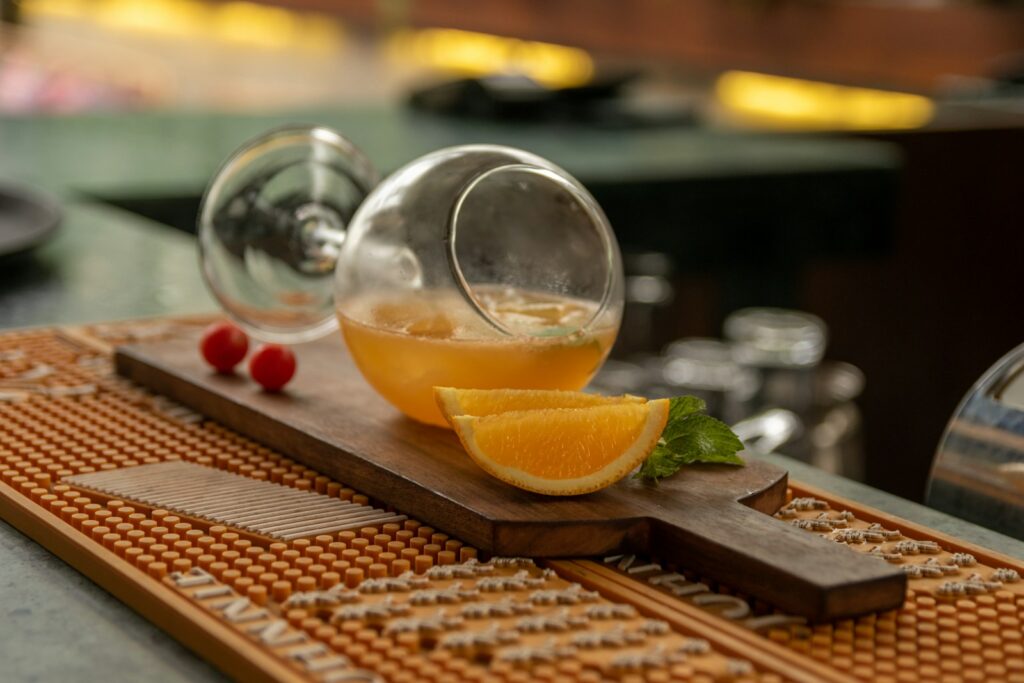 a wooden cutting board topped with a sliced orange